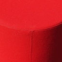 Round ottoman upholstered in various colorful fabric