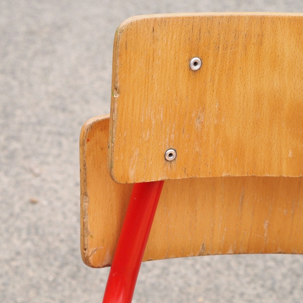 Stackable school chair with red tubular steel legs