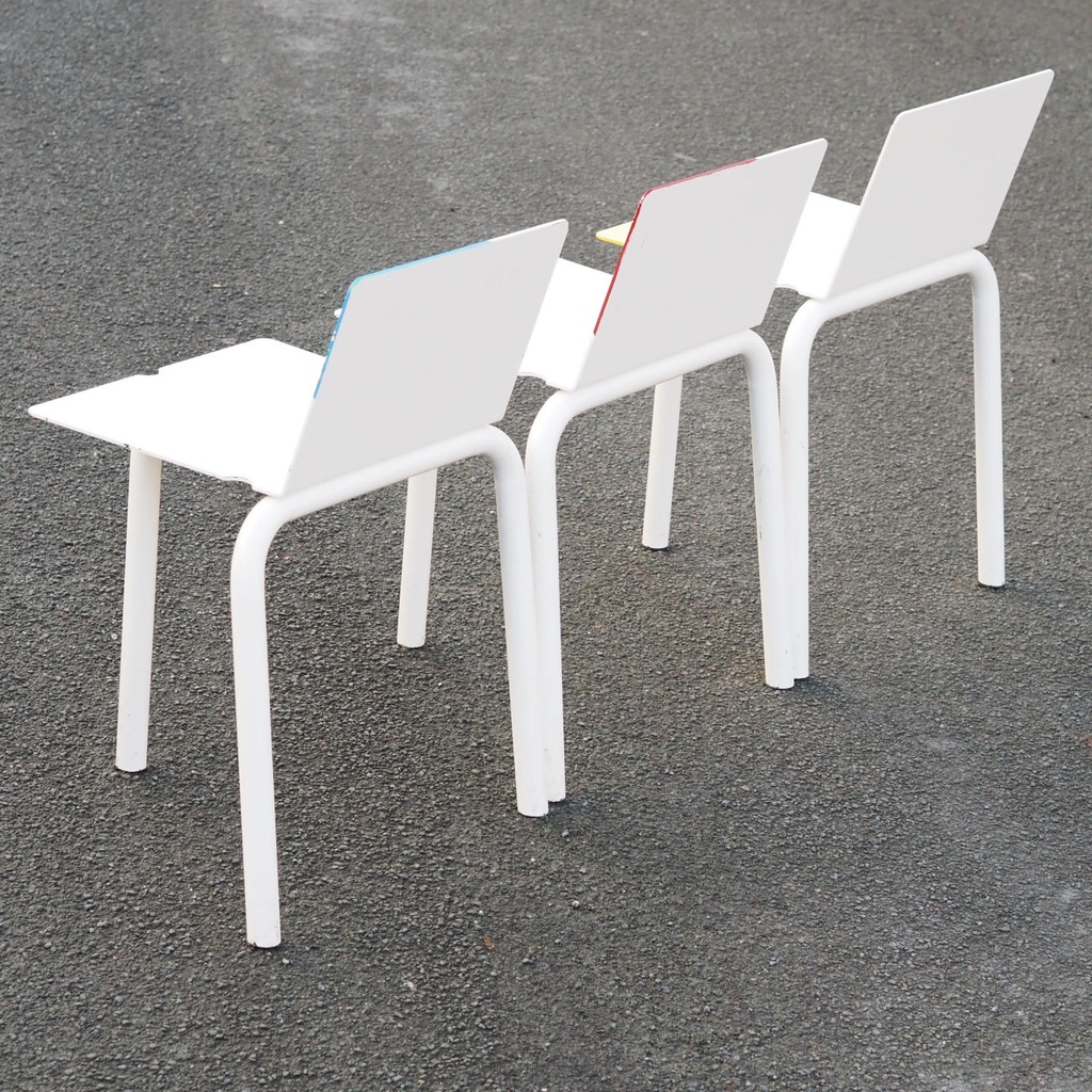 White stackable chair by Pierre-Emmanuel Vandeputte (with various coloured corners)