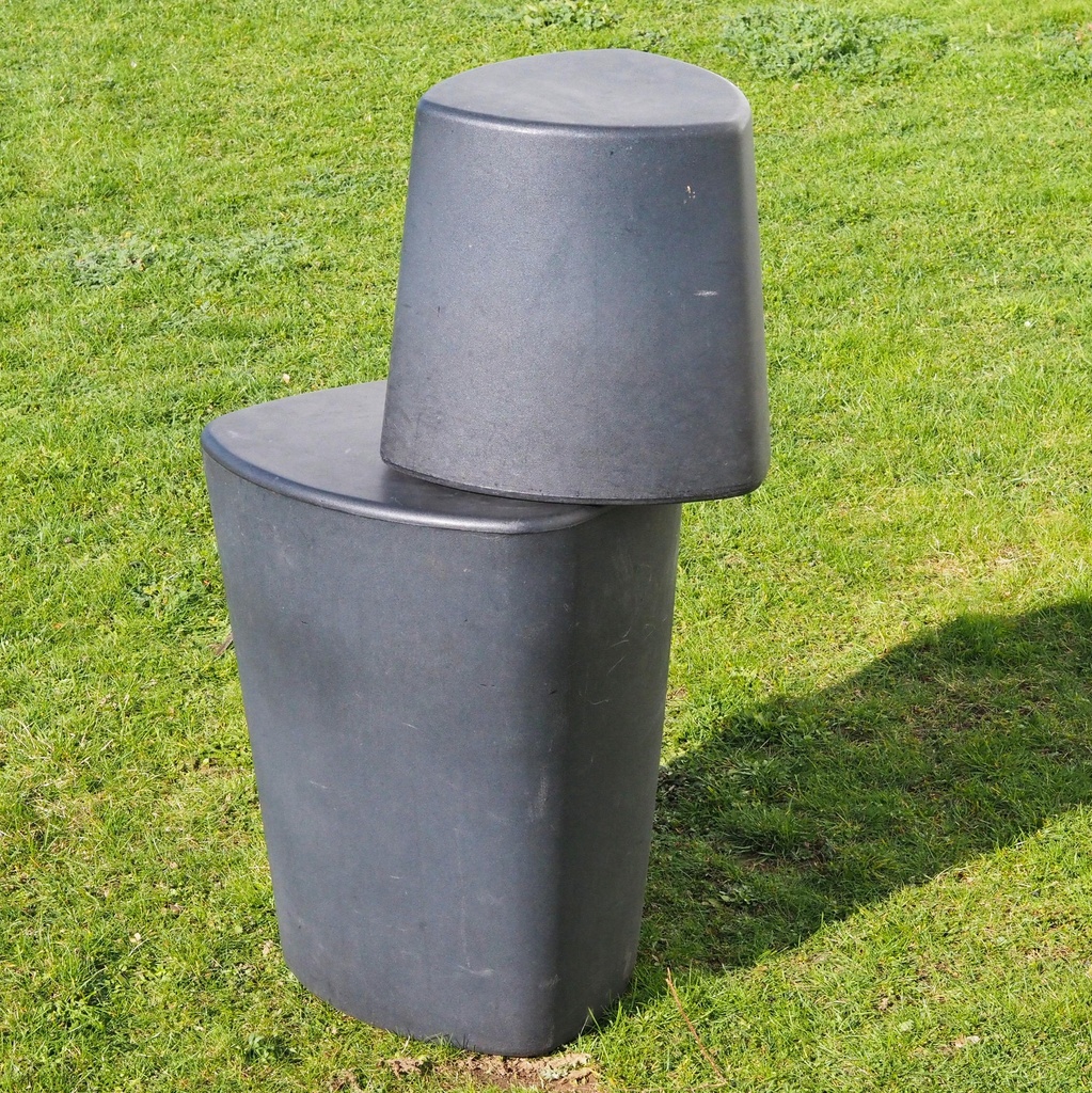 Round ottoman upholstered in various colorful fabric