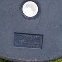 Round ottoman upholstered in various colorful fabric